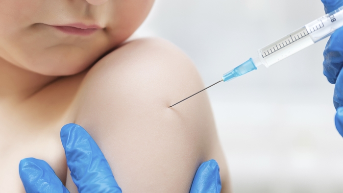 Boy and vaccine syringe