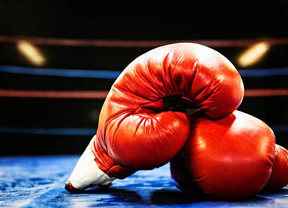 Boxing gloves in boxing ring. Grain added.